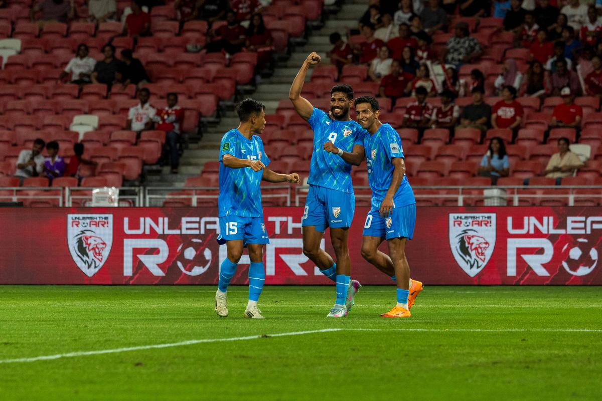 Rahim Ali (centre) celebrates scoring his first senior international goal with teammates, Sahal Abdul Samad (right) and Udanta Singh (left).