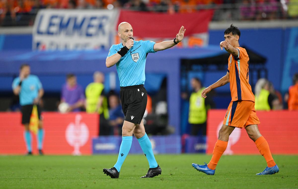 Referee Anthony Taylor gestures to rule out the goal scored by Xavi Simons of the Netherlands for offside following a VAR review.