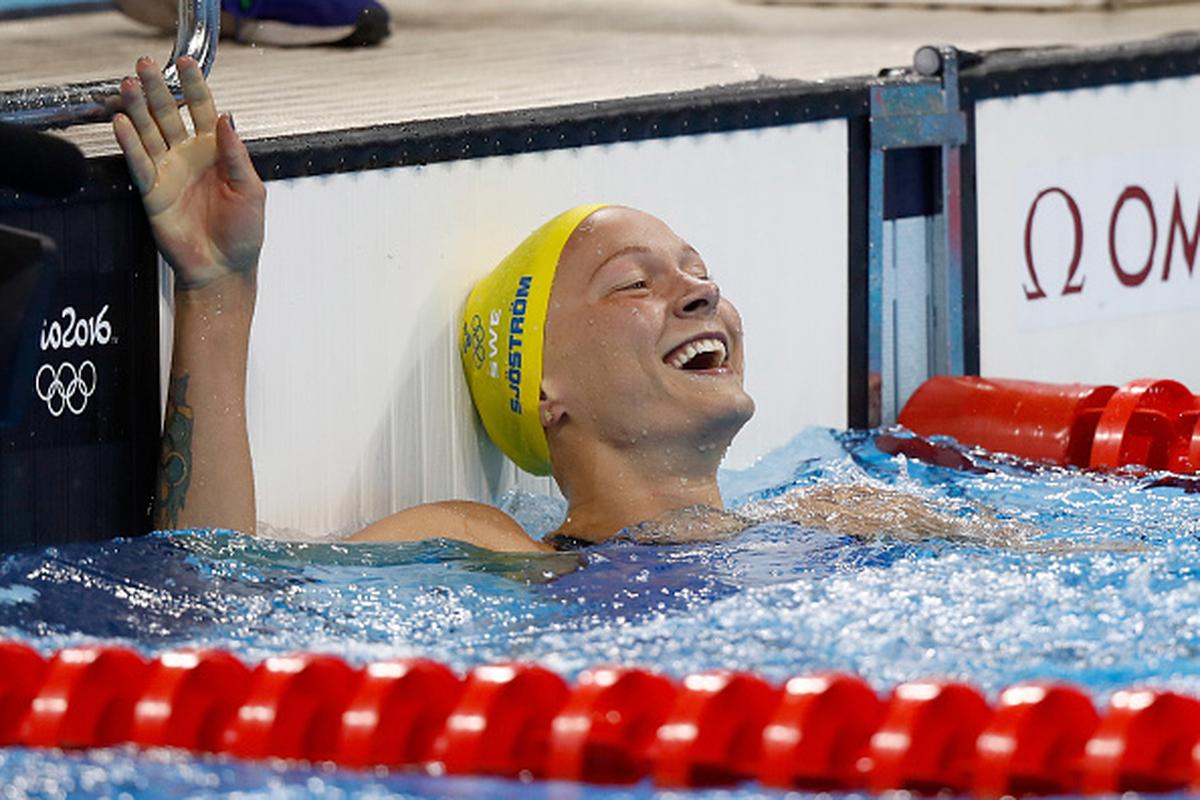 Sweden’s Sarah Sjostrom celebrates winning gold and setting a new world record in the Women’s 100m Butterfly on Day 2 of the Rio Olympic Games at the Olympic Aquatics Stadium on August 7, 2016.