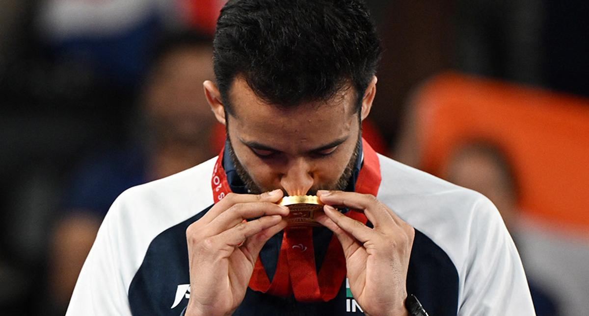 Paris Paralympics gold medallist Kumar Nitesh celebrates on the podium. 