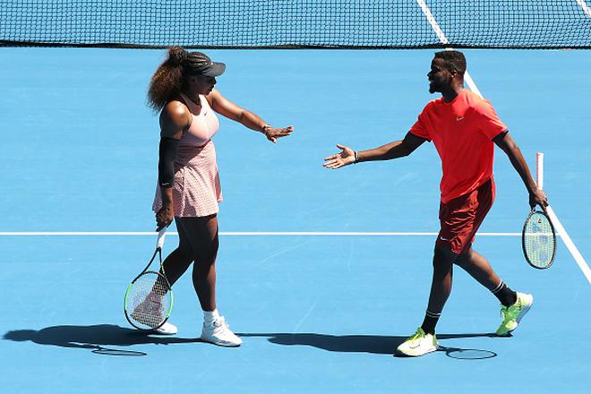 FILE PHOTO: Serena Williams (left) and Frances Tiafoe (right) of the United States celebrate a point in the mixed doubles match against Katie Boulter and Cameron Norrie of Great Britain during the 2019 Hopman Cup at RAC Arena on January 03, 2019 in Perth, Australia.