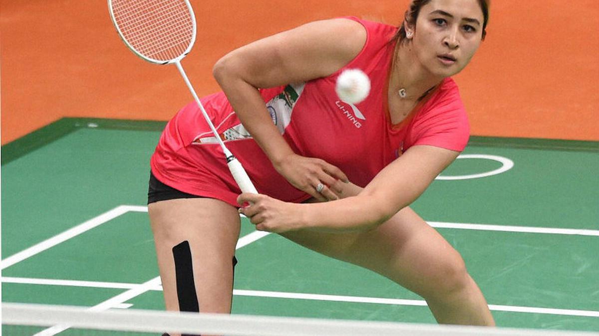 Jwala Gutta, positioned near the net, prepares to return a shot with her signature style. She and her partner won a bronze medal at the 2011 World Championships, making history in doubles.