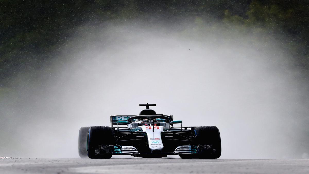 Hamilton takes stunning pole in wet conditions