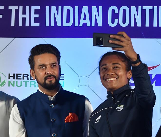 A happy moment: Indian athlete Hima Das takes a selfie with Youth Affairs and Sports Minister, Anurag Thakur, during the send-off ceremony of the Indian contingent for Birmingham Commonwealth Games, at Ashoka Hotel in New Delhi on July 7, 2022.