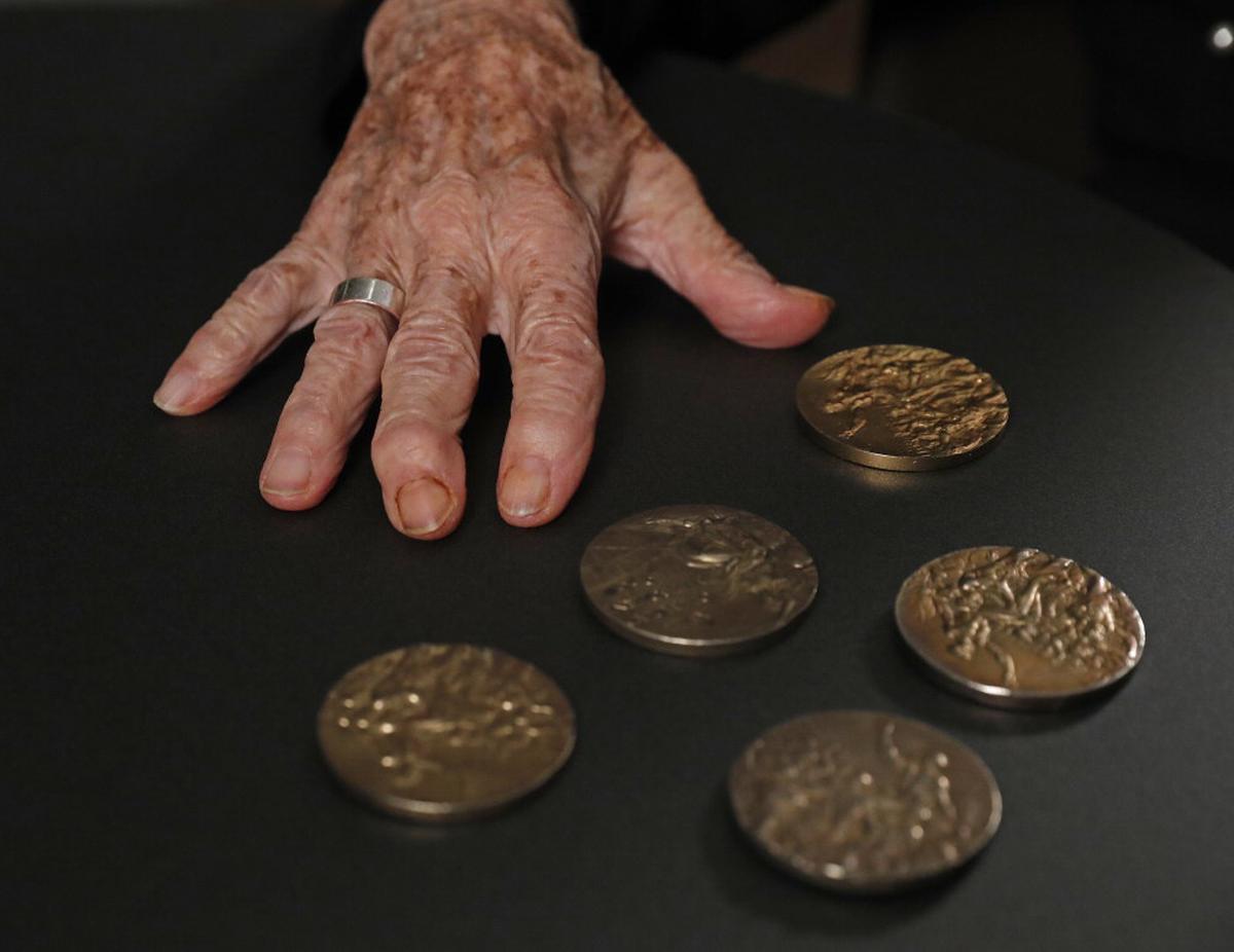 Keleti displays the Olympic medals she won at 1952 Helsinki and 1956 Melbourne Games.