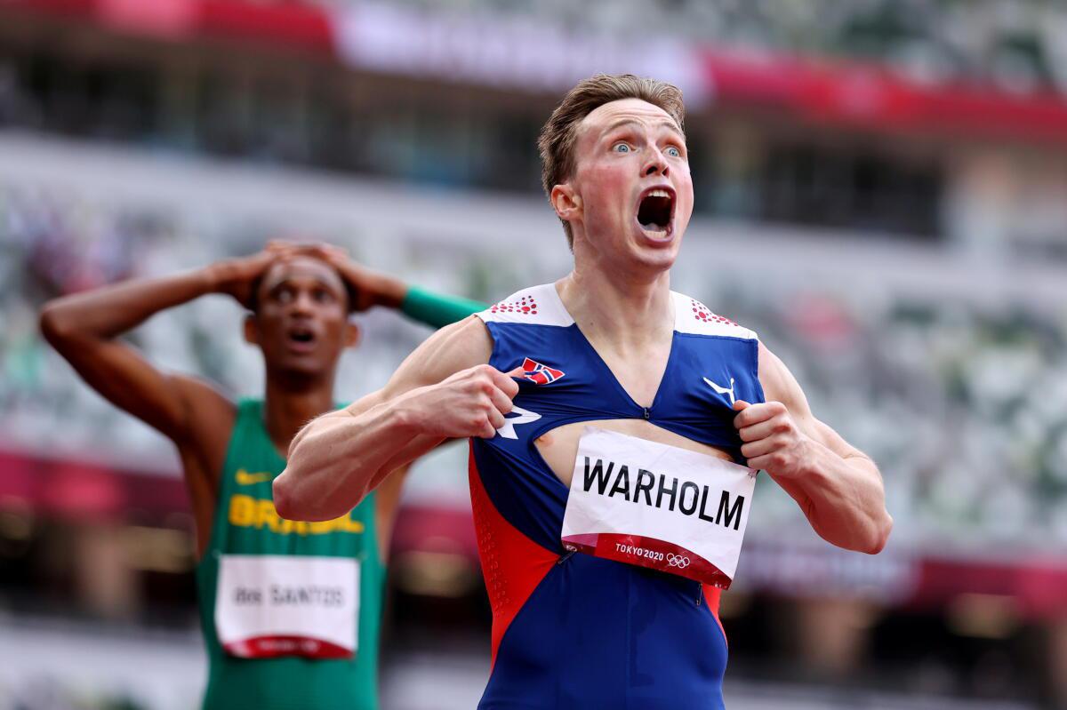 Norway’s Karsten Warholm reacts after setting a new world record of 45.94s in men’s 400m hurdles at the Tokyo 2020 Olympic Games.