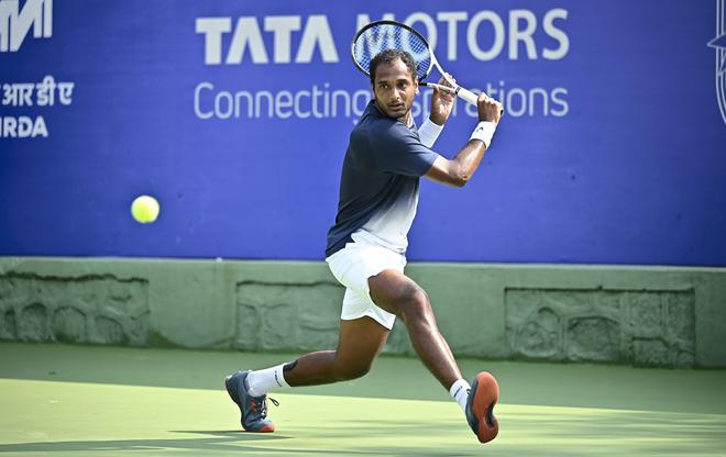 Fighting a lone battle: Ramkumar Ramanathan prepares for a backhand return during his opening round singles match against Spain’s Pedro Martinez. Ramkumar was the only Indian to make it to the main draw – he came through the qualifying round.