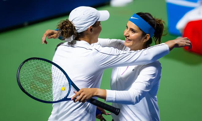 Eventful career: Sania Mirza of India hugs partner Madison Keys of the United States after finishing her last-ever career match, in the Dubai Duty Free Tennis tournament in February.