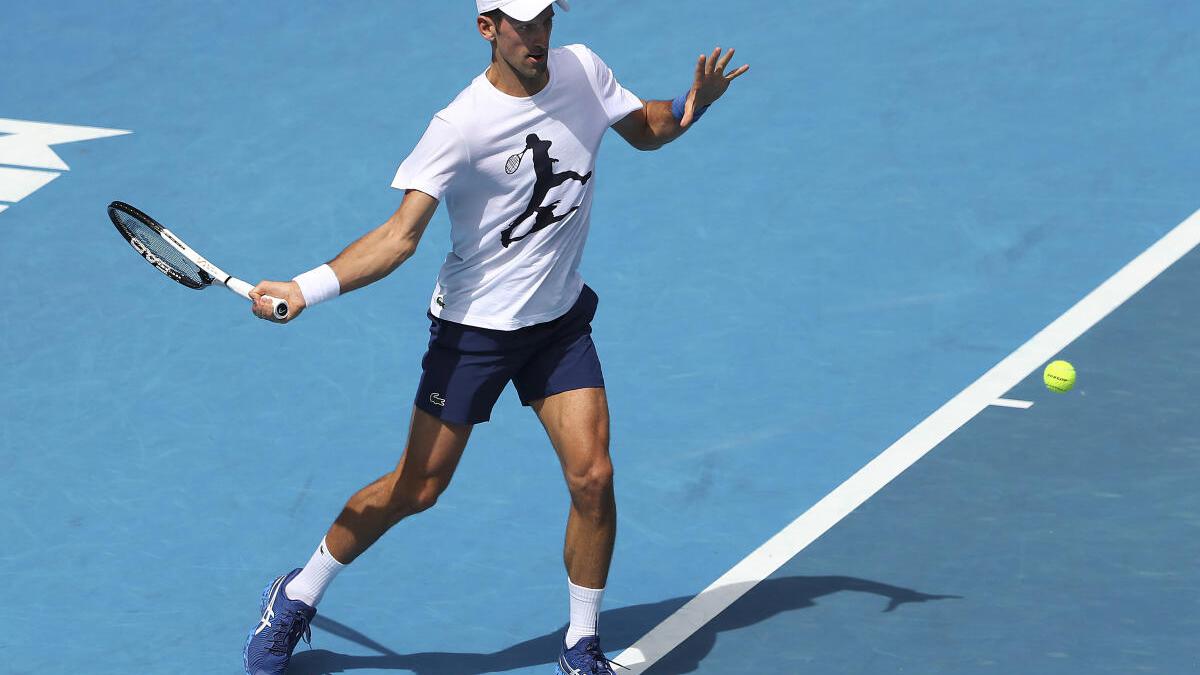 Djokovic back into swing in Australia, visa questions linger